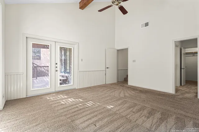 an empty room with windows and closet