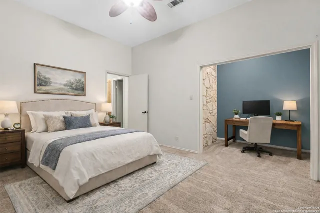 a bedroom with a bed and a desk