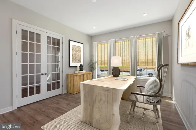 a room with a bed and wooden floor