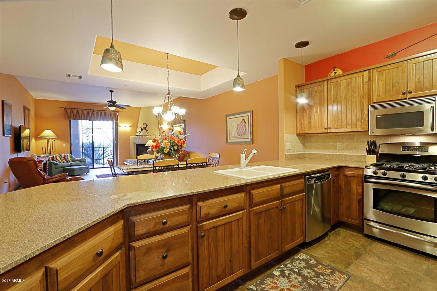 36601 North Mule Train Road, Unit 8A Carefree, AZ 85377 - Photo 11 of 50 a kitchen with stainless steel appliances granite countertop a sink a stove and a wooden floors