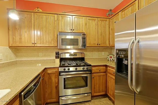 a kitchen with appliances cabinets and a counter top space