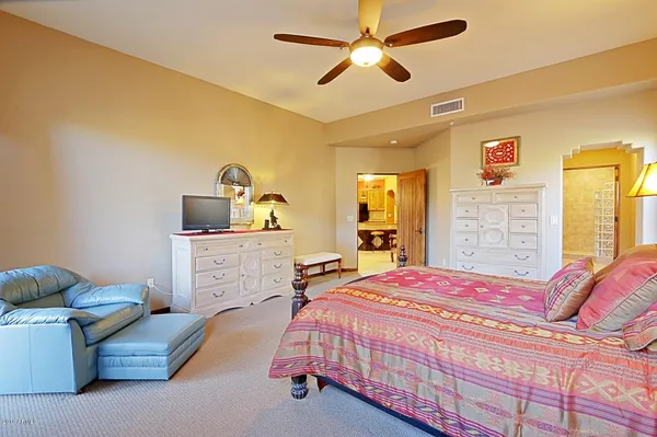 a bedroom with a bed and a chandelier