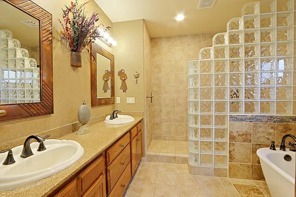 a bathroom with a double vanity sink mirror and