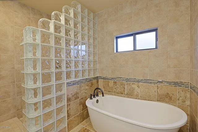 a bathroom with a bathtub and shower