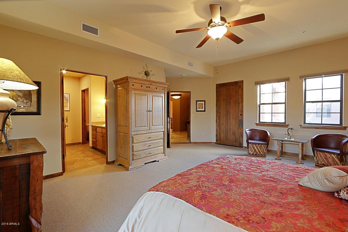 36601 North Mule Train Road, Unit 8A Carefree, AZ 85377 - Photo 21 of 50 a bedroom with furniture and a chandelier