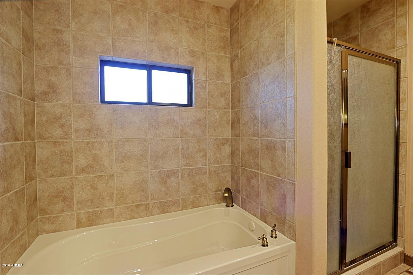 36601 North Mule Train Road, Unit 8A Carefree, AZ 85377 - Photo 23 of 50 a bath tub sitting next to a window