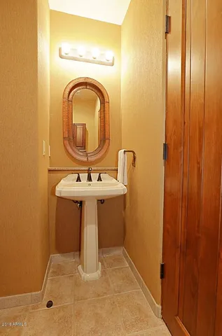 a bathroom with a sink a mirror and a window