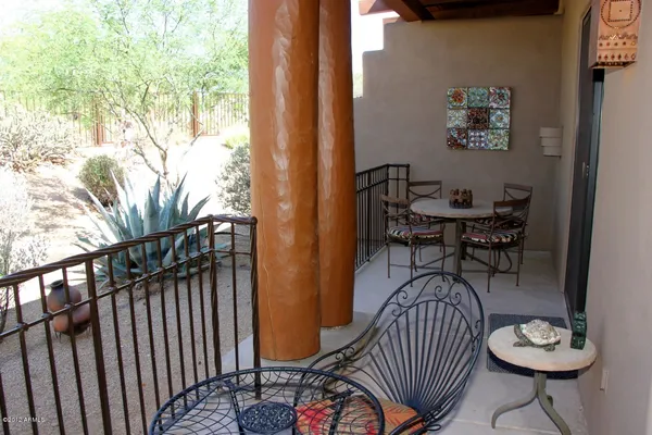a view of a balcony with chairs