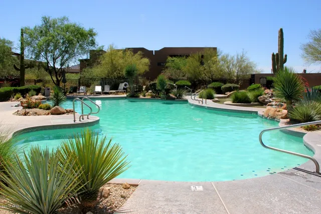 a view of a swimming pool with a yard