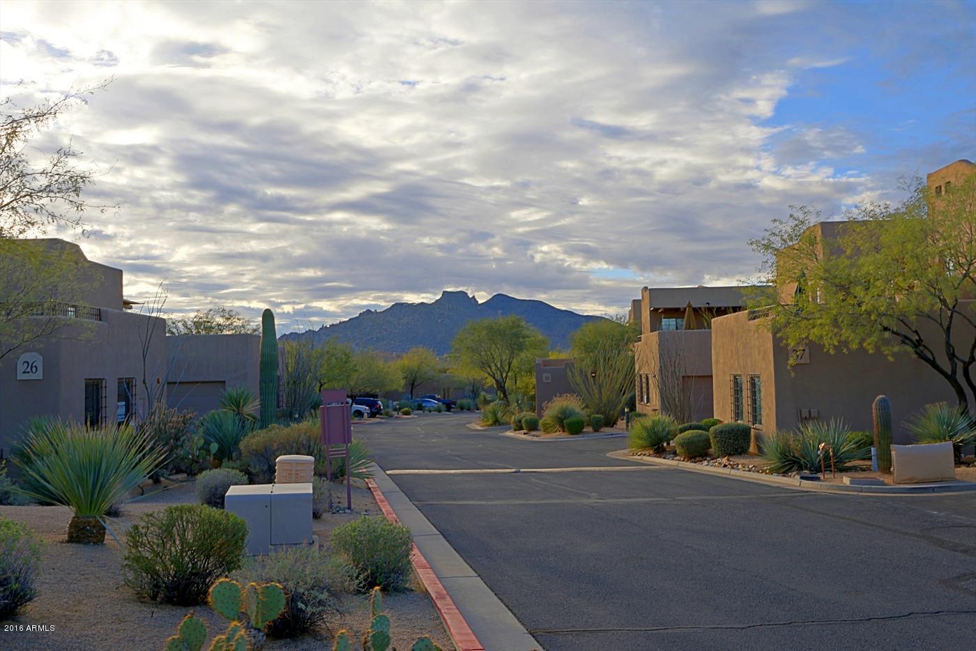 36601 North Mule Train Road, Unit 8A Carefree, AZ 85377 - Photo 49 of 50 a view of a patio with couches and table and chairs and potted plants