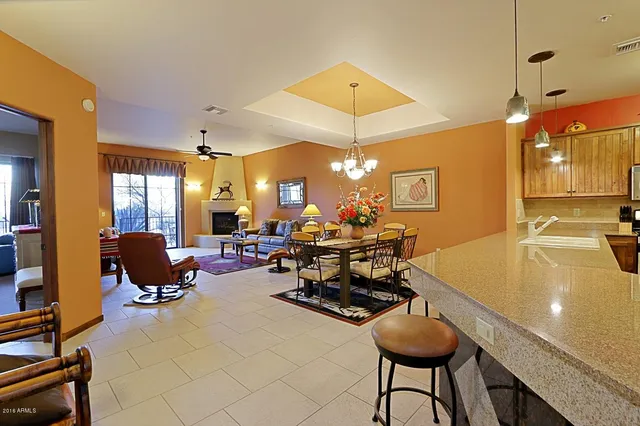a living room with lots of furniture and chandelier