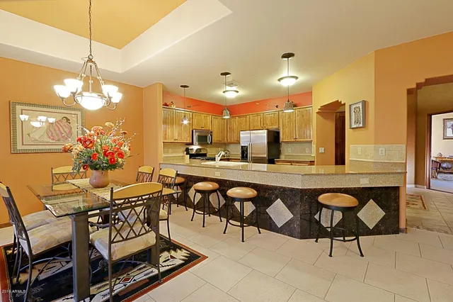 a view of a dining room with furniture and chandelier