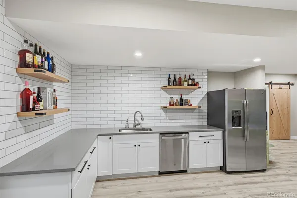 a kitchen with stainless steel appliances granite countertop a refrigerator and a sink