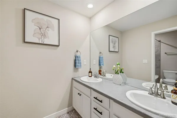 a bathroom with a double vanity sink and a mirror