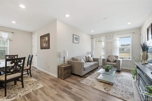 a living room with furniture wooden floor and a flat screen tv