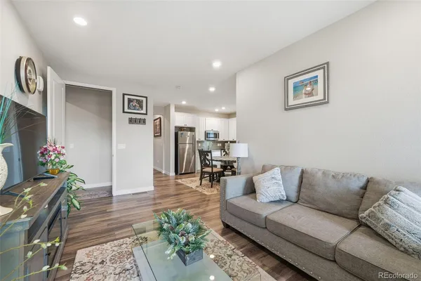 a living room with furniture and flowers