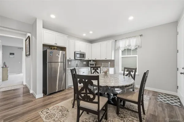 a view of a dining room with furniture and wooden floor
