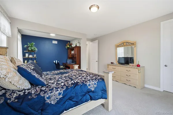 a bedroom with a bed and a dresser