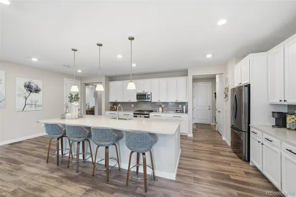 a large kitchen with a table and chairs