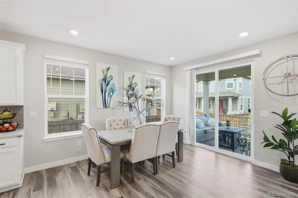 a view of a dining room with furniture window and wooden floor