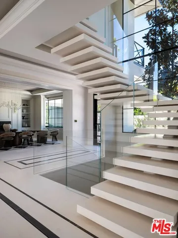 a spacious bedroom with a large bed and a fireplace