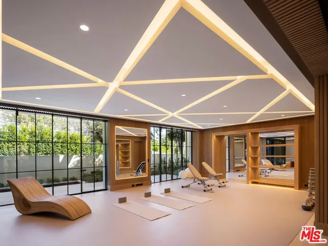 a spacious bedroom with a bed a couch and a flat screen tv