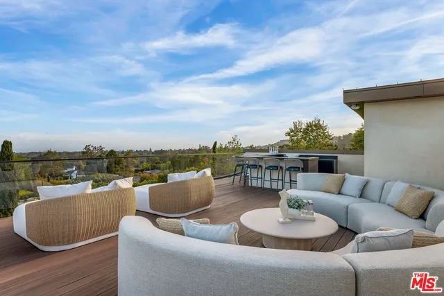 a view of a patio with dining table and chairs