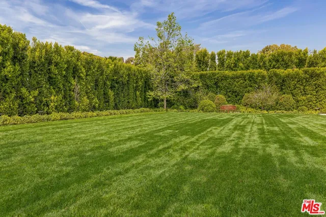 a view of a house with swimming pool and sitting area