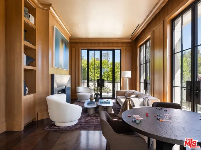 a living room with furniture and large windows