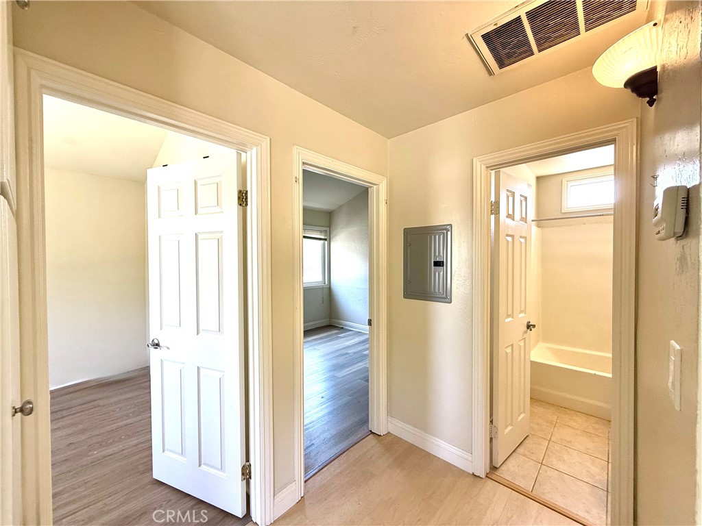 2242 Elden Avenue Costa Mesa, CA 92627 - Photo 8 of 14 a view of a hallway with wooden floor and closet