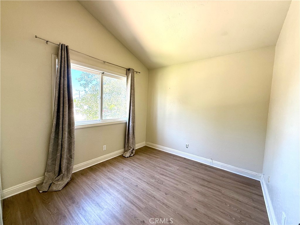 2242 Elden Avenue Costa Mesa, CA 92627 - Photo 9 of 14 an empty room with wooden floor and windows