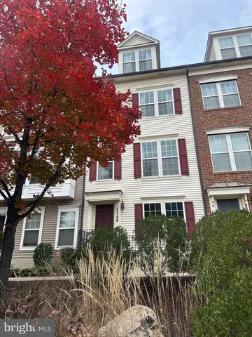 a front view of a house with plants