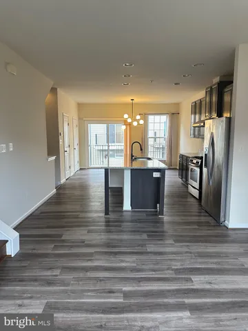 a view of a kitchen with dining table and chairs
