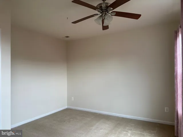 an empty room with a fan