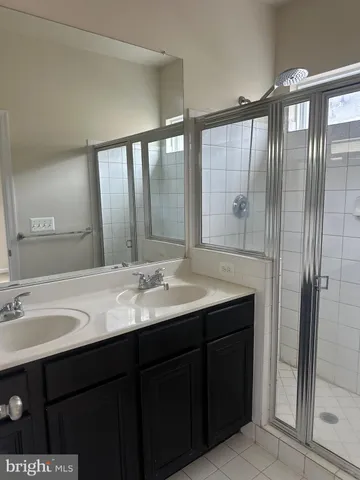 a bathroom with a double vanity sink and mirror