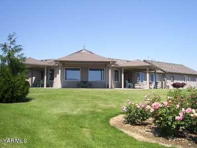 12216 West Barrett Road Yakima, WA 98908 - Photo 1 of 21 a front view of a house with a garden