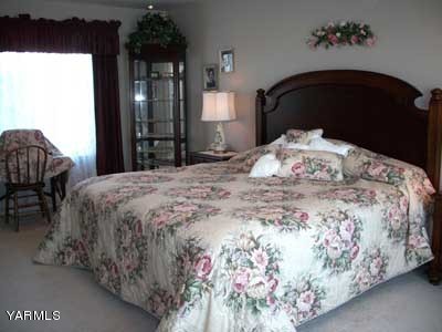 12216 West Barrett Road Yakima, WA 98908 - Photo 11 of 21 a bedroom with a bed and a mirror