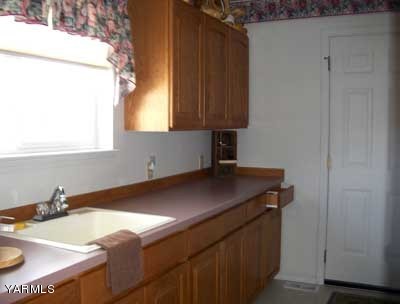 12216 West Barrett Road Yakima, WA 98908 - Photo 14 of 21 a room with a sink cabinets and a window