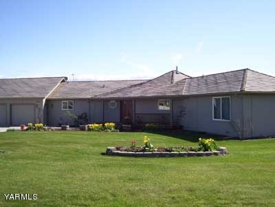 12216 West Barrett Road Yakima, WA 98908 - Photo 3 of 21 a front view of a house with a garden