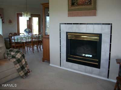 12216 West Barrett Road Yakima, WA 98908 - Photo 7 of 21 a living room with furniture a table and a fireplace