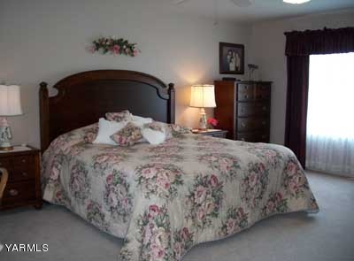 12216 West Barrett Road Yakima, WA 98908 - Photo 10 of 21 a bedroom with a bed and a television