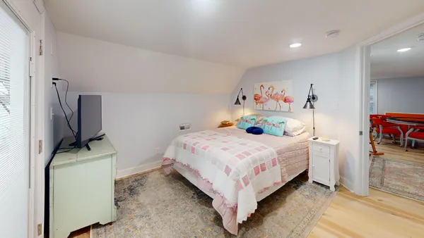a bedroom with a bed and a flat screen tv