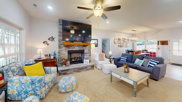 a living room with furniture a fireplace and a flat screen tv