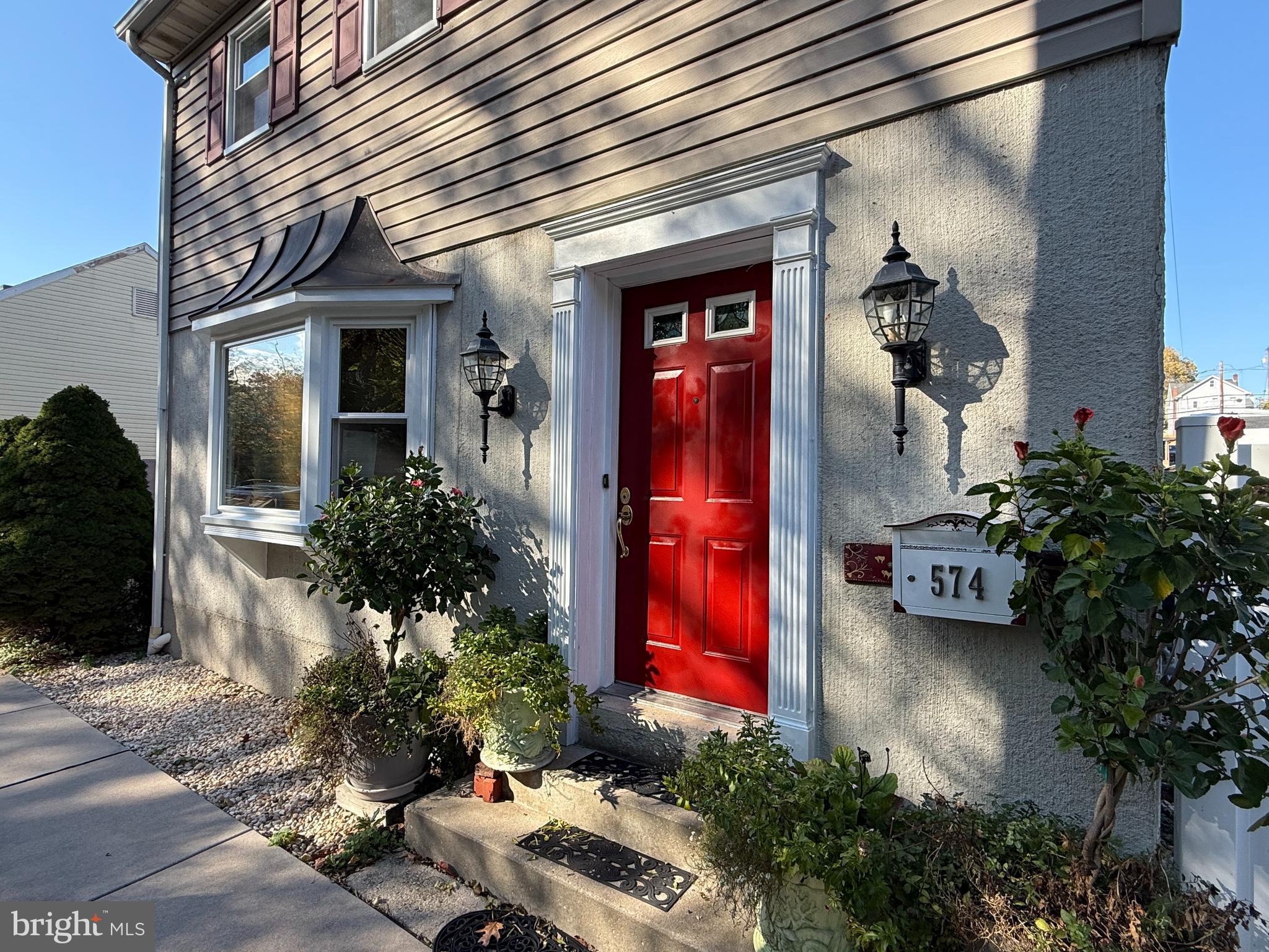 a view of front door of house and car parked