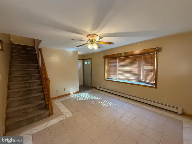 a view of an empty room with staircase