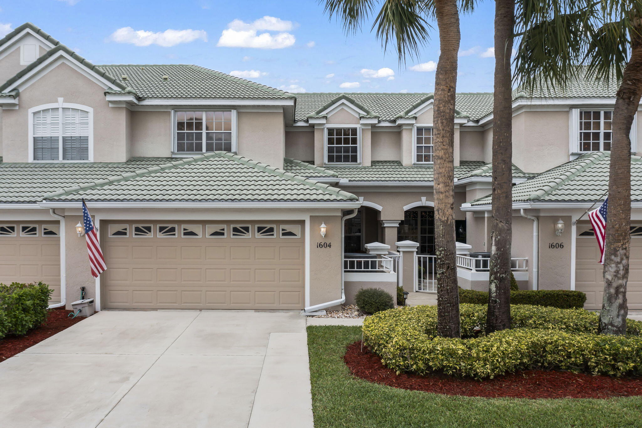 1604 Southwest Harbour Isles Circle, Unit 82 Port St. Lucie, FL 34986 - Photo 1 of 38 front view of a house with a yard