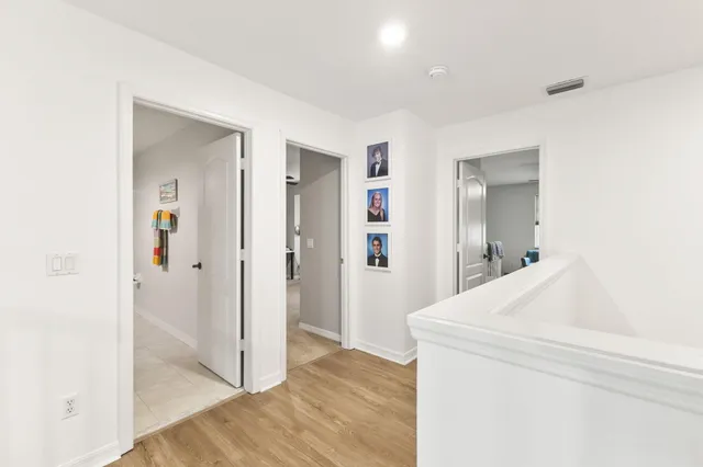a view of hallway with wooden floor