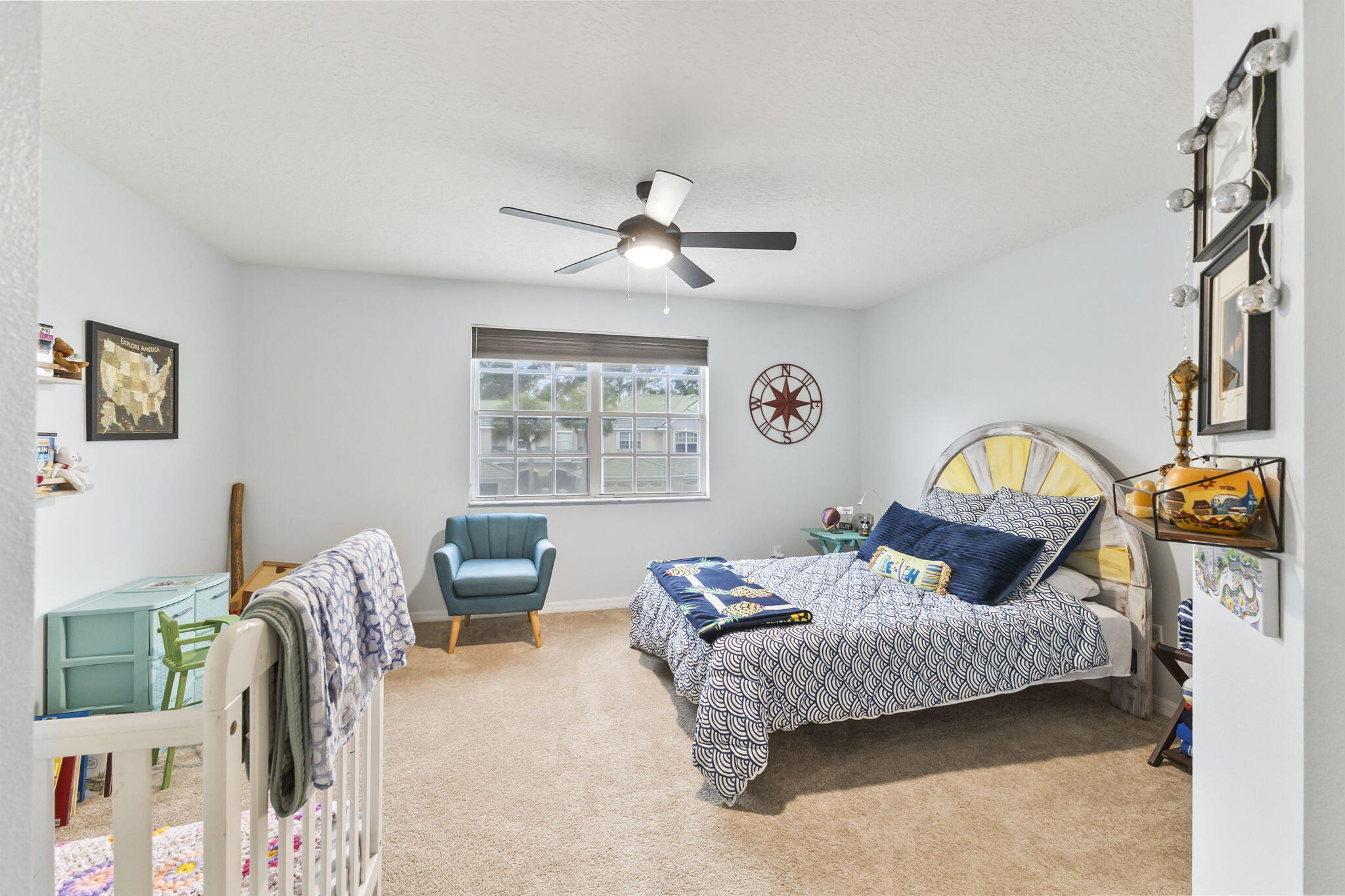 1604 Southwest Harbour Isles Circle, Unit 82 Port St. Lucie, FL 34986 - Photo 20 of 38 a bedroom with furniture and a chandelier