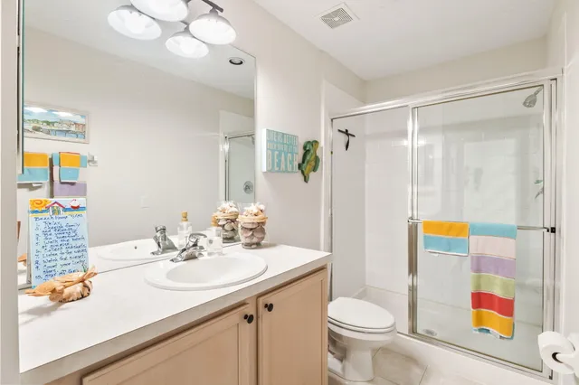 a bathroom with a sink a toilet and shower curtain