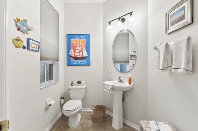 a bathroom with a toilet a sink and mirror